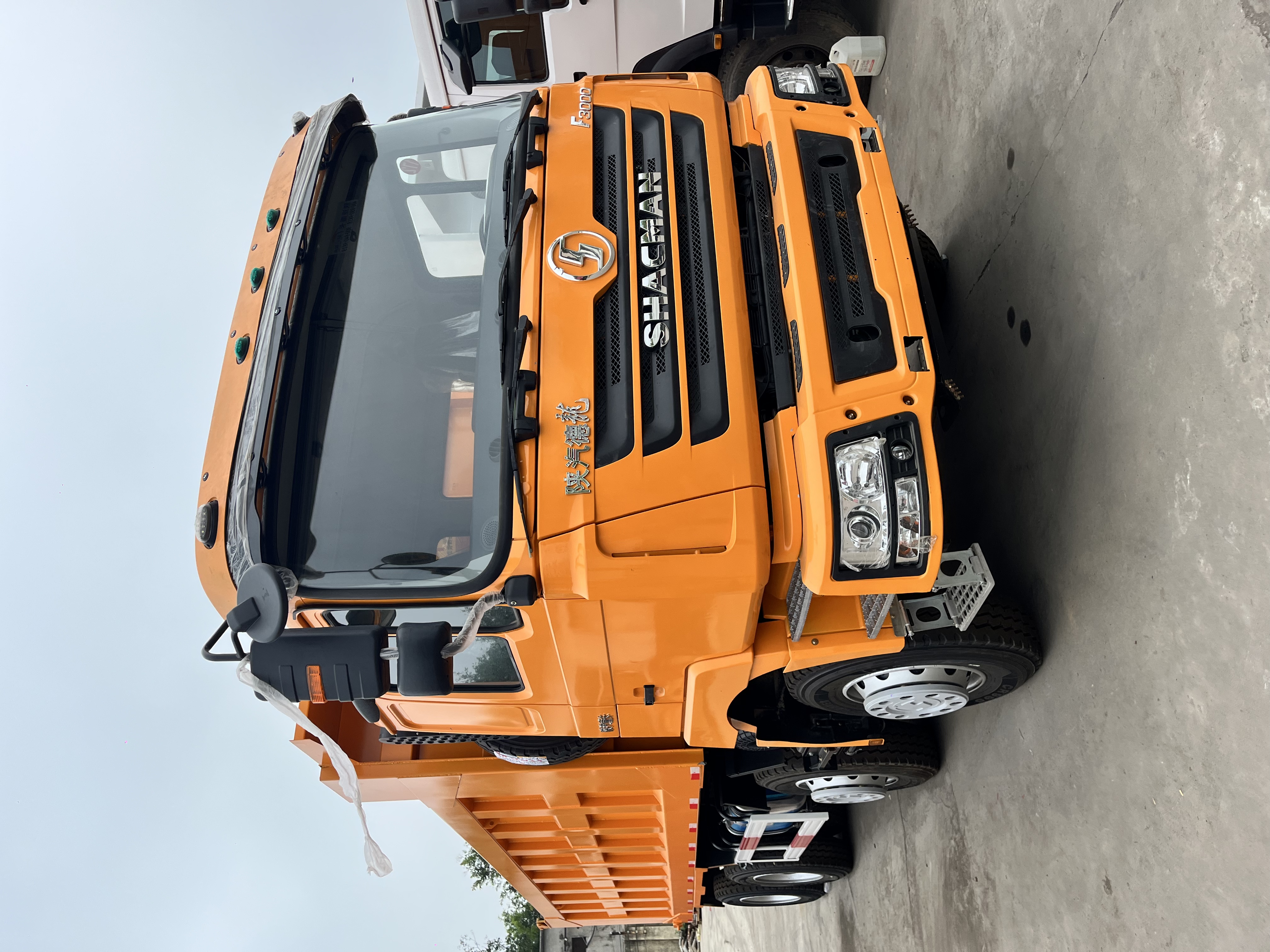 Orange SHACMAN F3000 dump truck